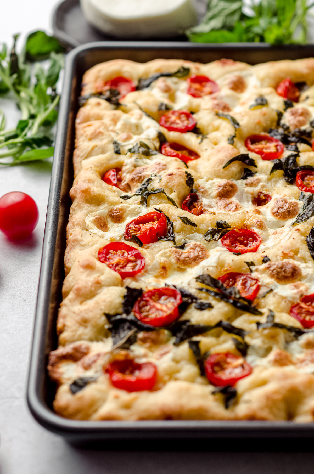 Caprese focaccia in a baking dish.