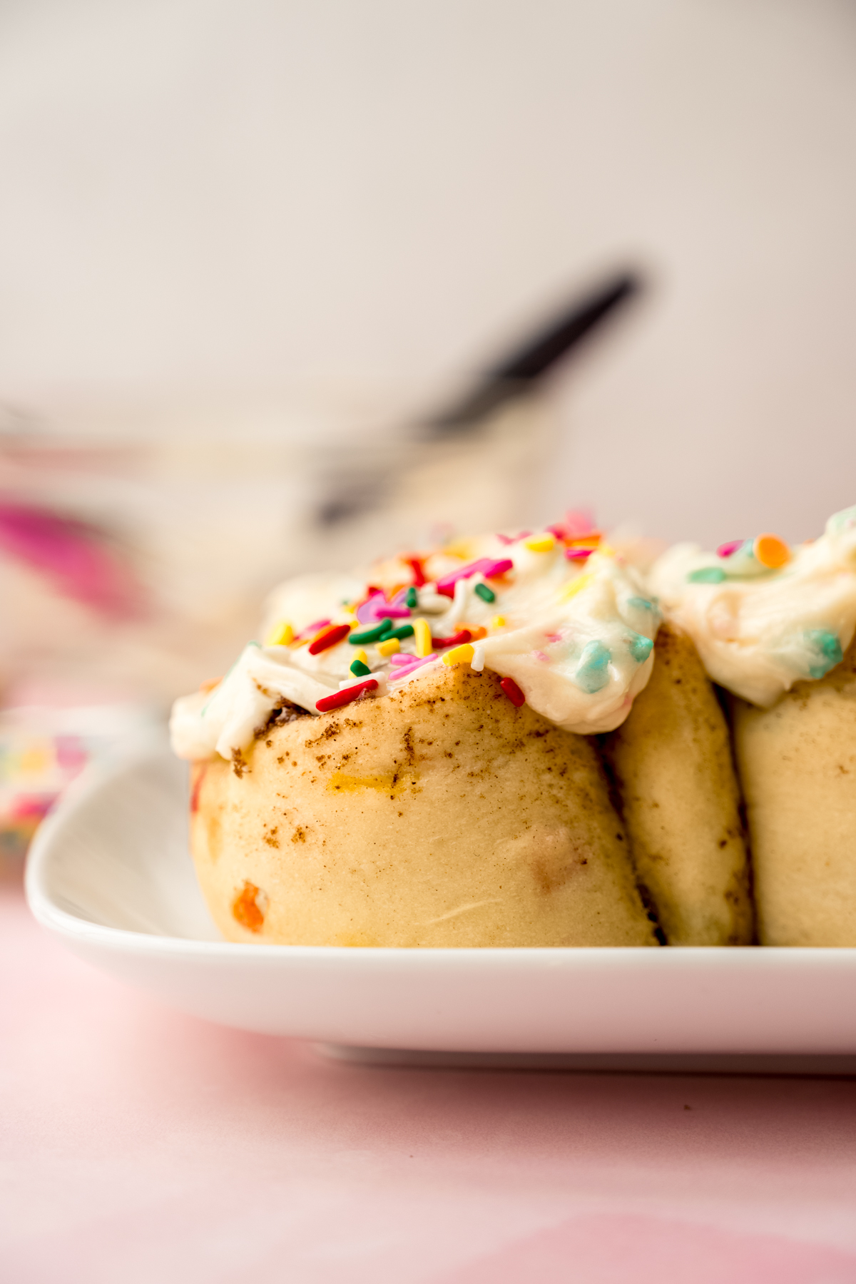 Funfetti cinnamon rolls on a plate.