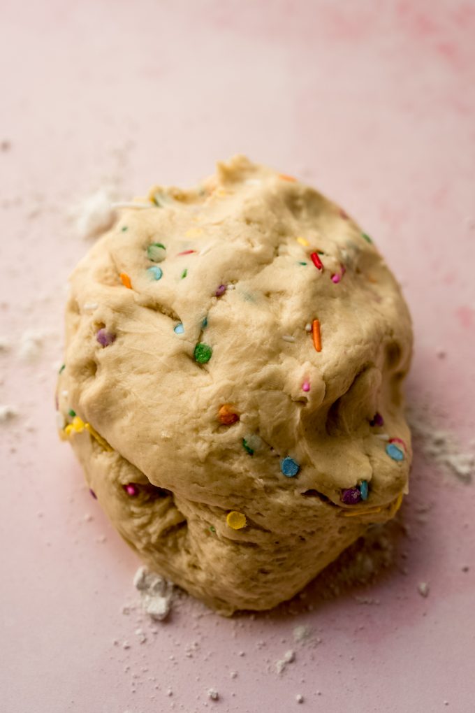 Funfetti cinnamon roll dough on a surface.