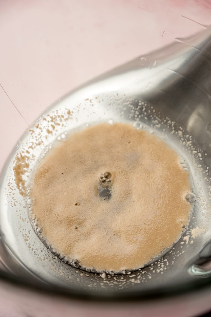 Yeast and water in the bottom of the bowl of a stand mixer.