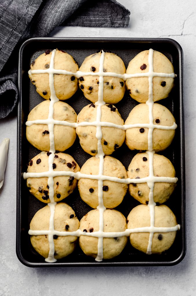 Aerial photo of hot cross buns in a baking pan ready to bake.