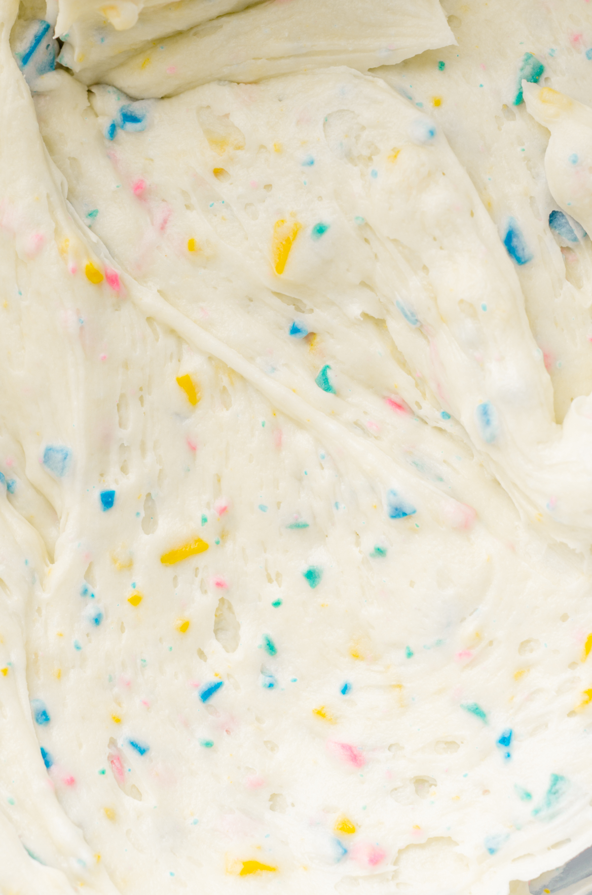 A closeup of rainbow chip frosting.