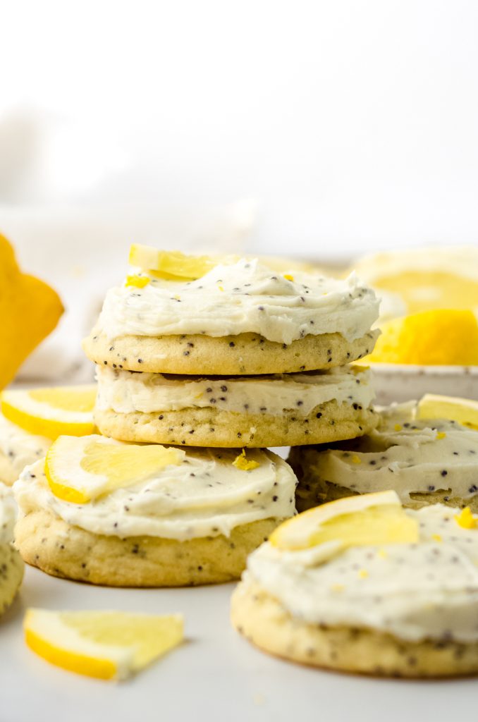 A stack of frosted lemon poppy seed cookies.