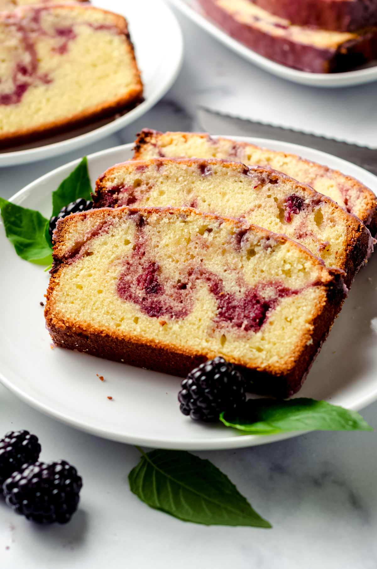 Slices of blackberry pound cake on a plate.