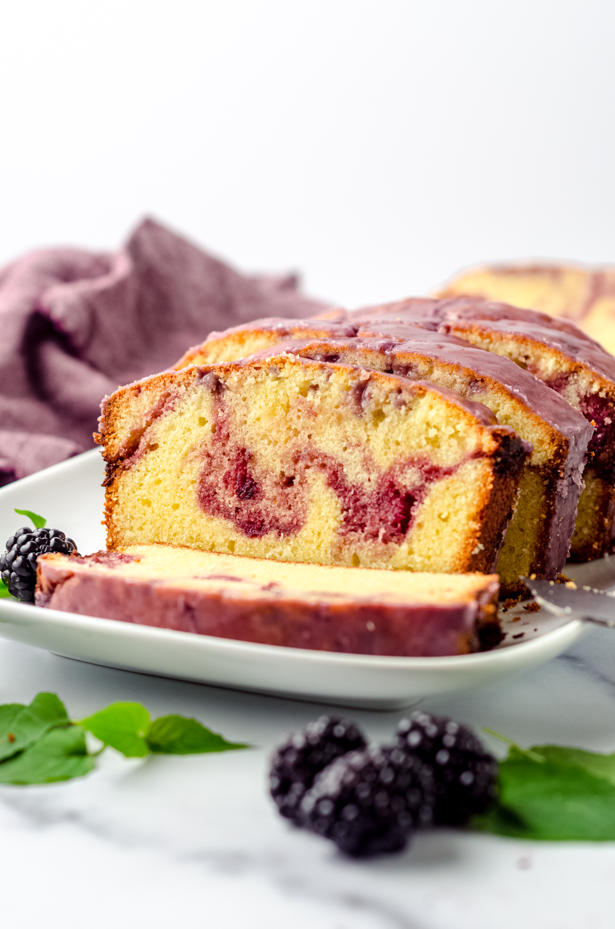 Slices of blackberry pound cake on a plate.