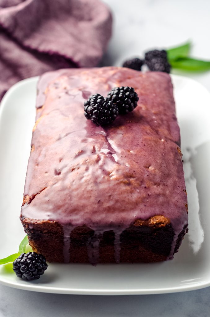 Blackberry pound cake loaf on a plate.