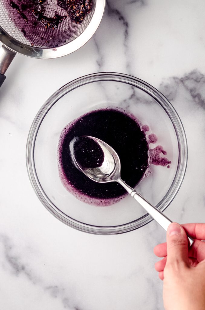 Aerial photo of a bowl of fresh blackberry juice.