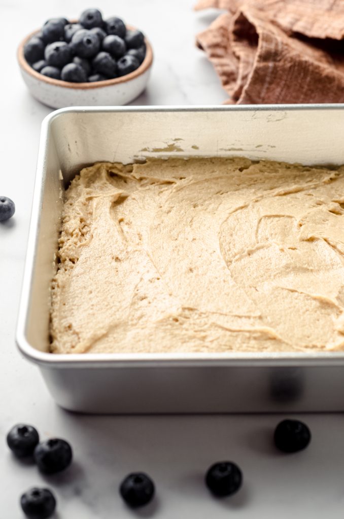 Coffee cake batter spread into a baking pan.