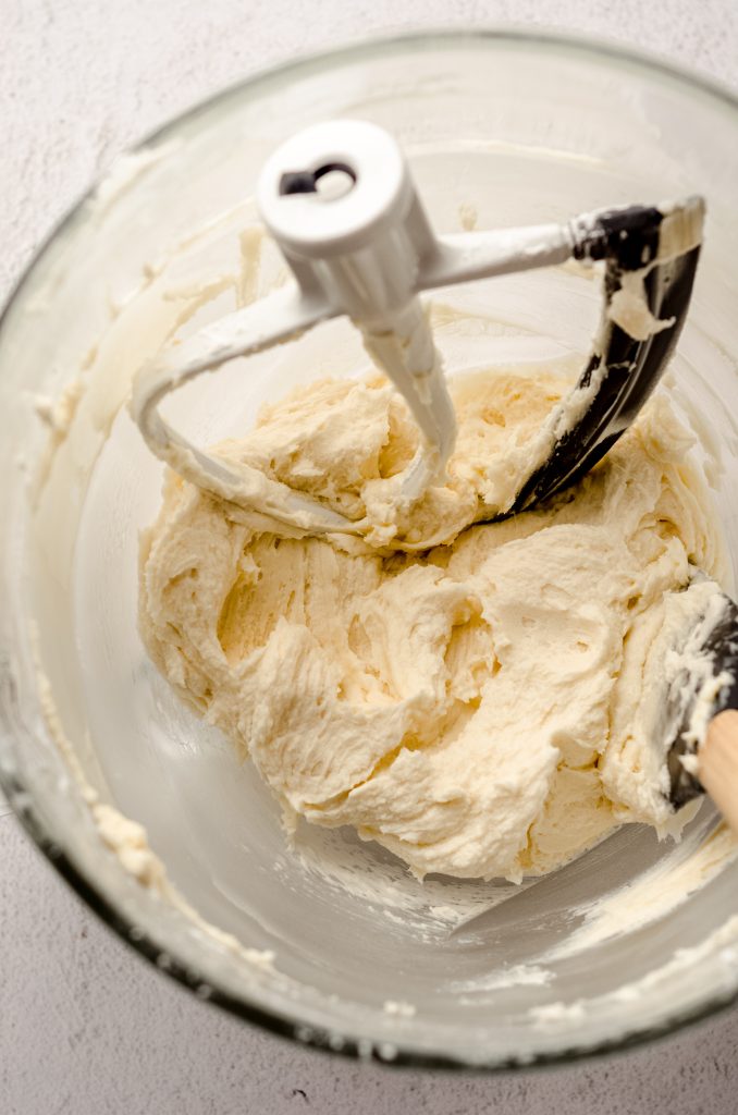 Vanilla buttercream in a bowl before pressing out air bubbles.