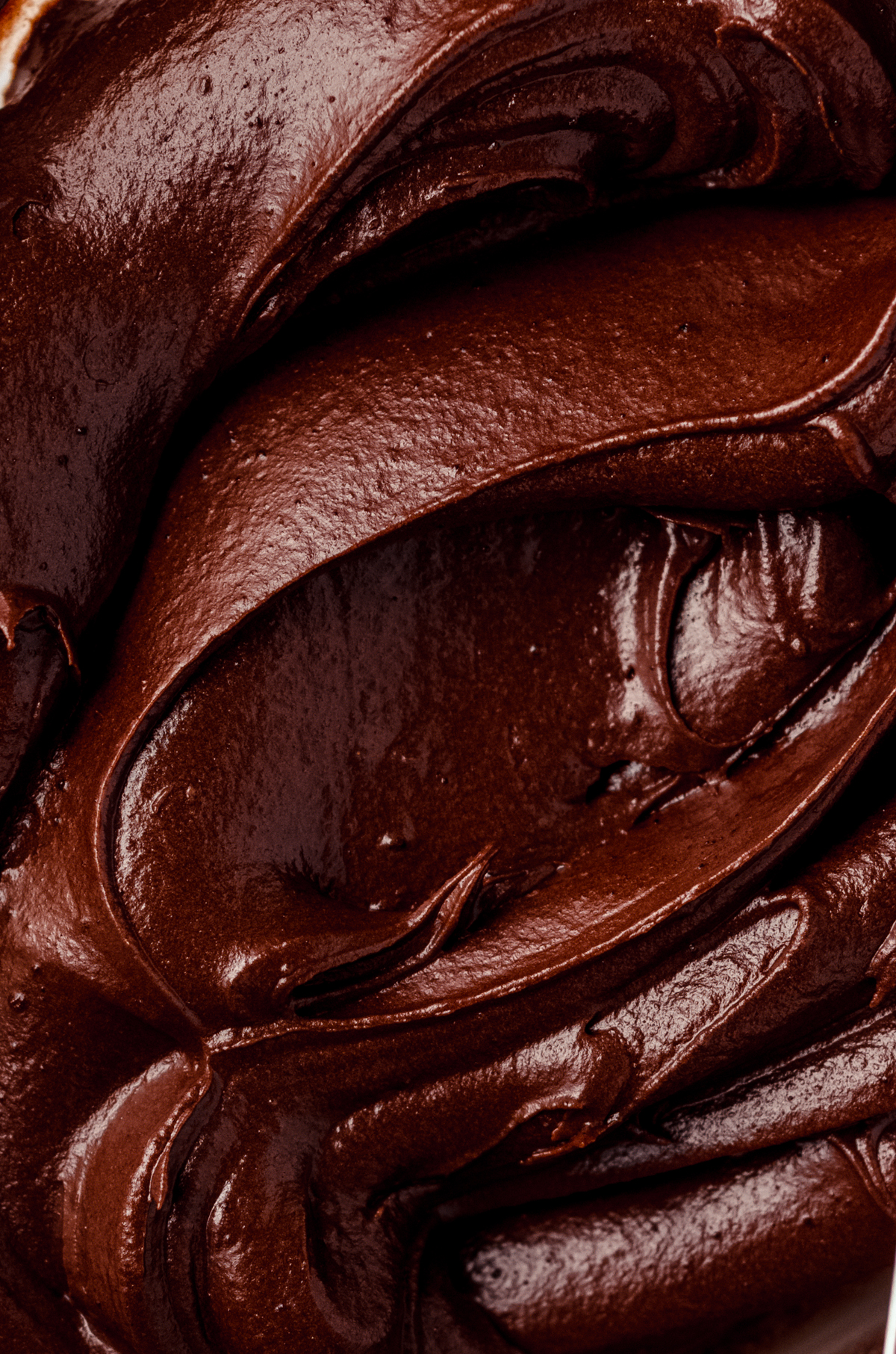 Closeup of chocolate frosting made with cocoa powder.