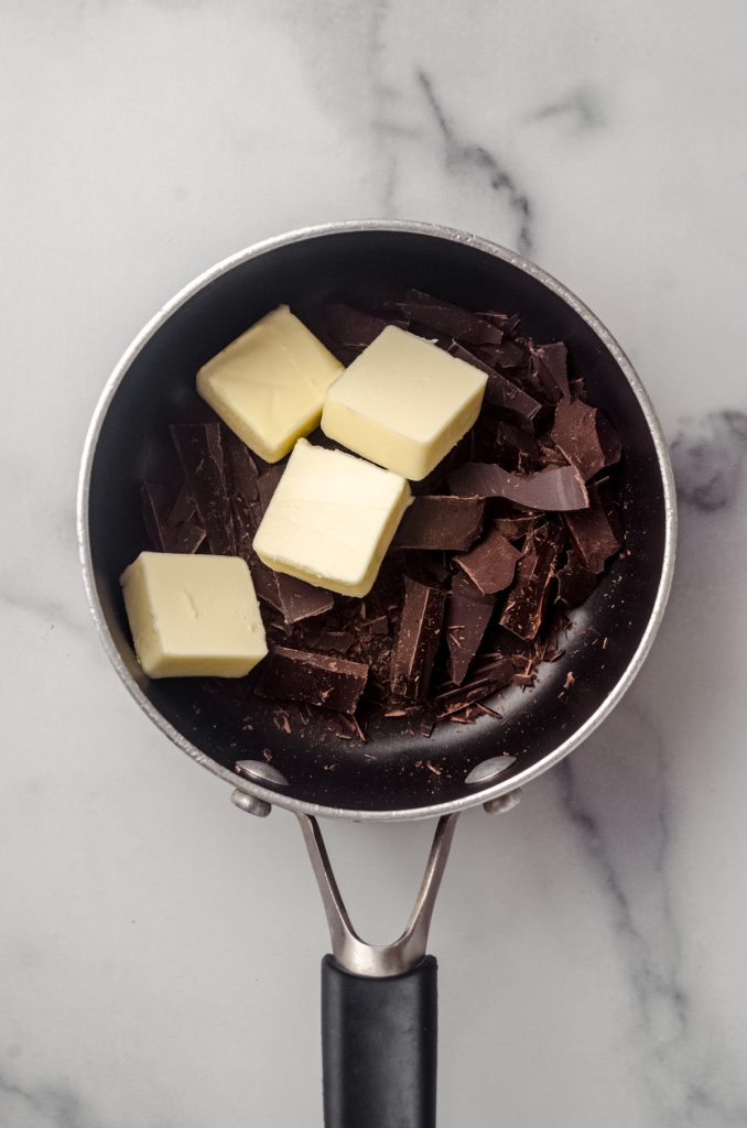 A saucepan with butter and chopped chocolate in it.
