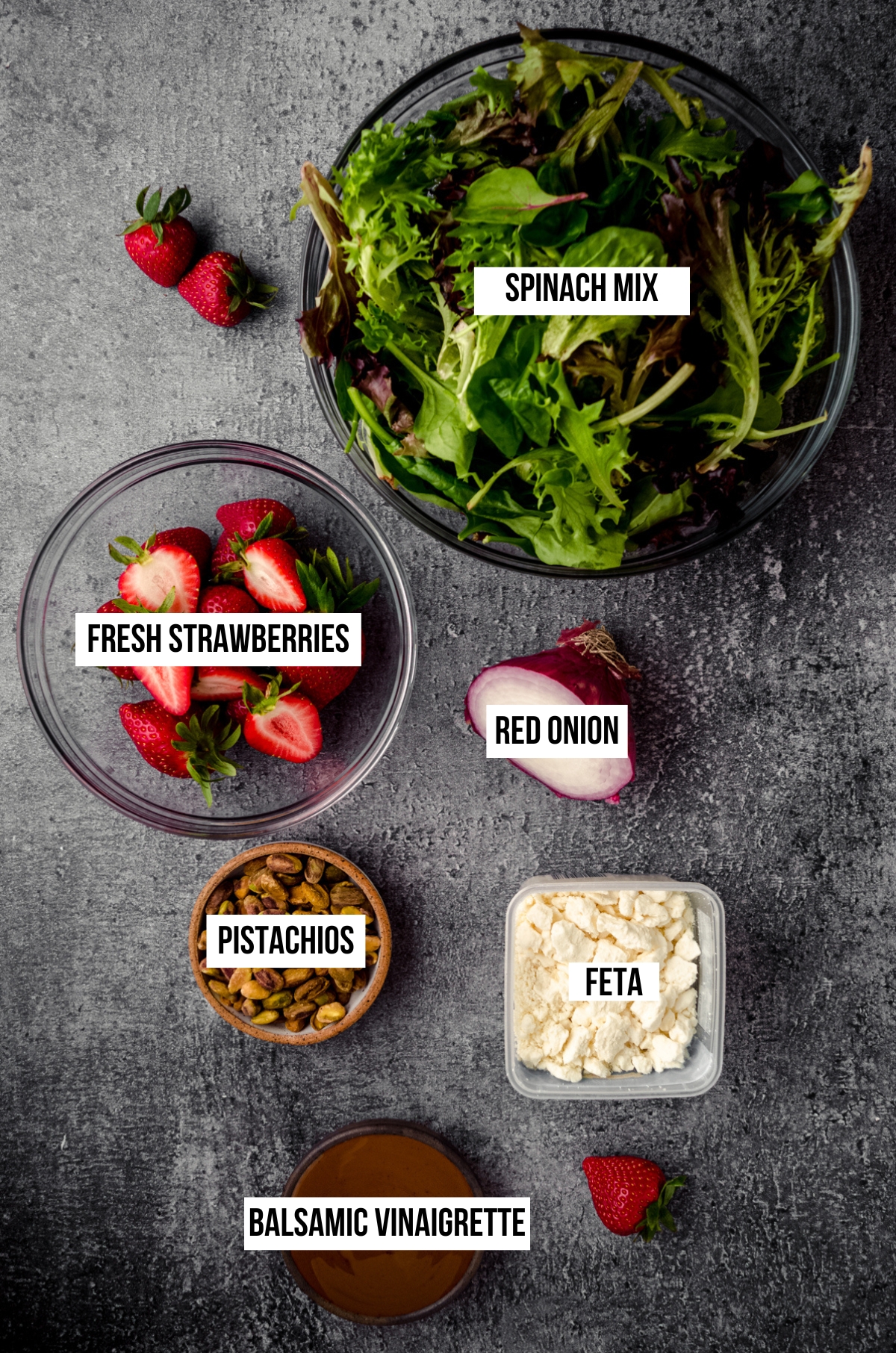 Ingredients for spinach salad with text overlay.