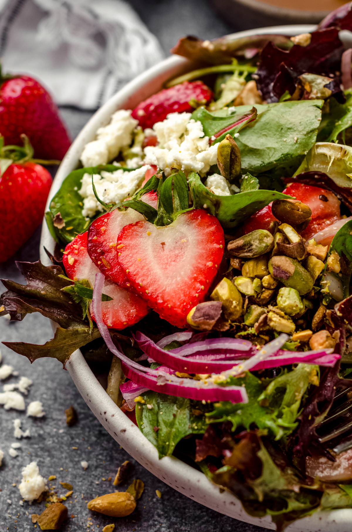 A bowl of strawberry spinach salad with feta.