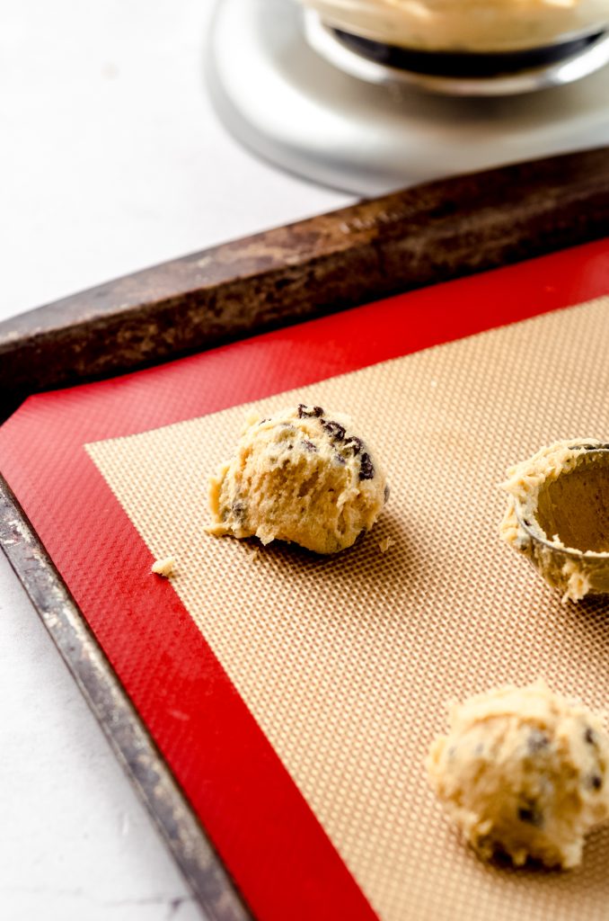 Cookie dough cookie balls on a baking sheet.