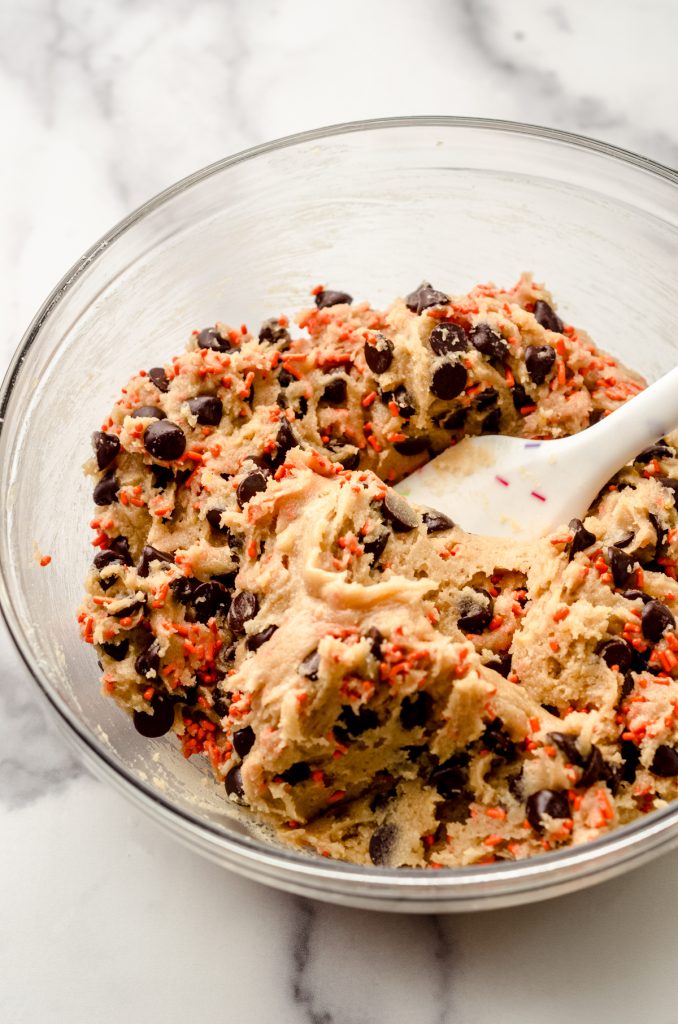 Halloween cookie cake dough in a glass bowl.