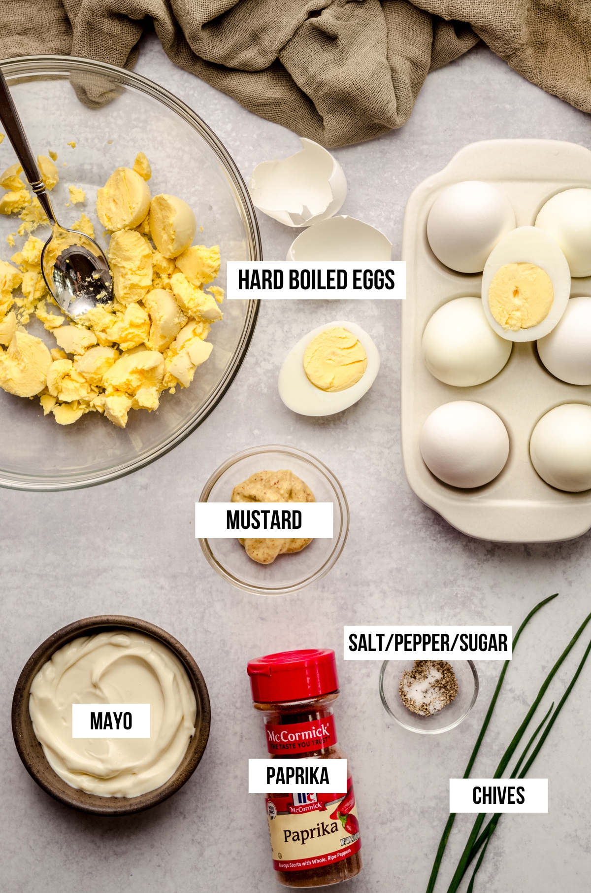 Aerial photo of ingredients for Halloween deviled eggs with text overlay.