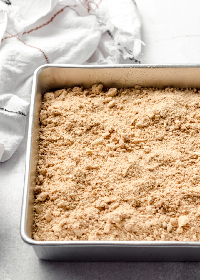 Pumpkin coffee cake with crumb topping in a baking pan.