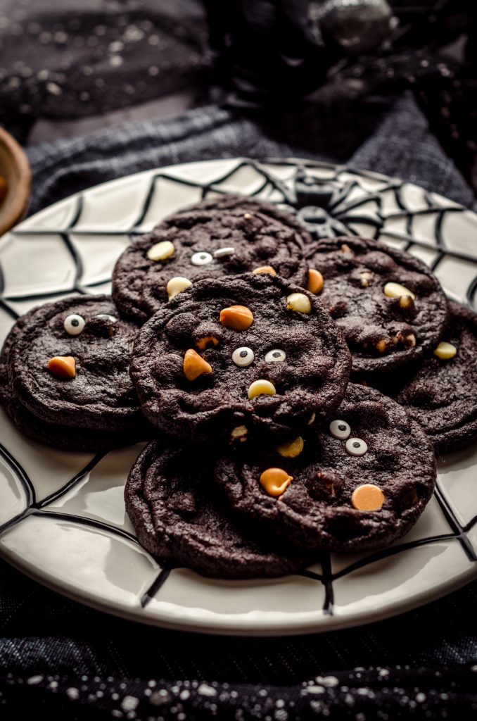 Chocolate Halloween cookies on a spider web plate.