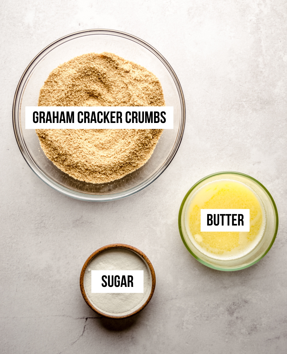 Aerial photo of ingredients for a graham cracker crust with text overlay.