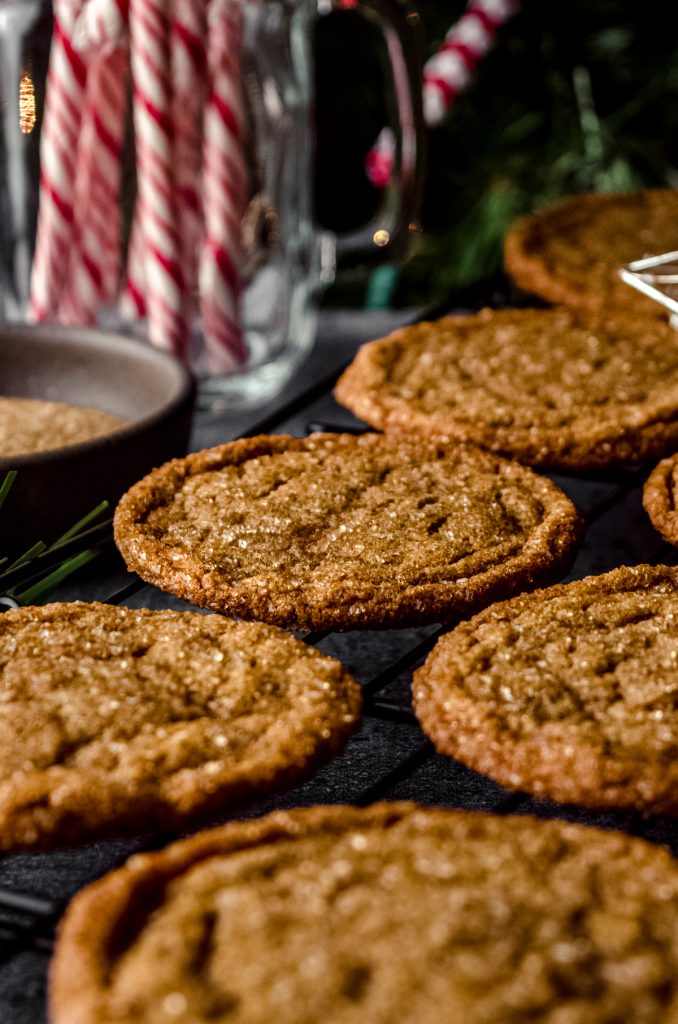 Chewy gingersnap cookies on a cooling rack.