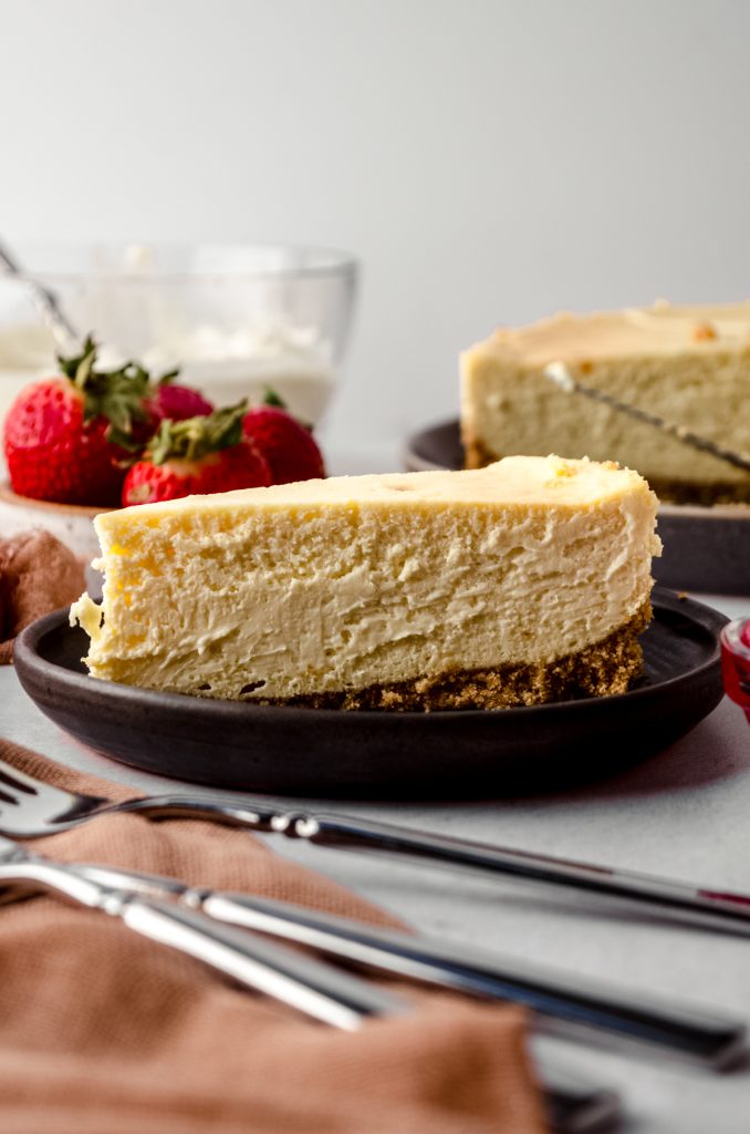 A slice of classic cheesecake on a plate.