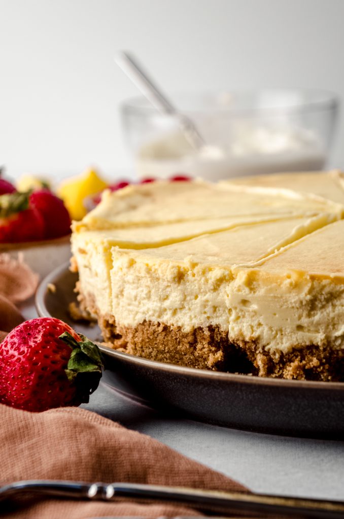 Classic cheesecake on a serving platter.