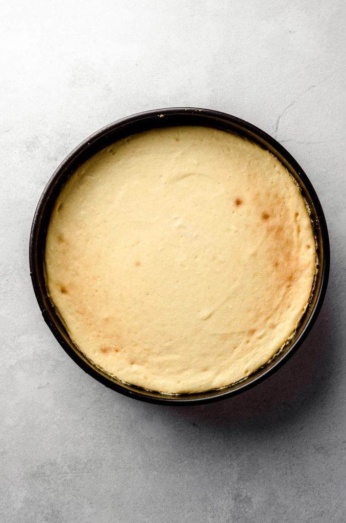 Aerial photo of a classic cheesecake baked in a pan.