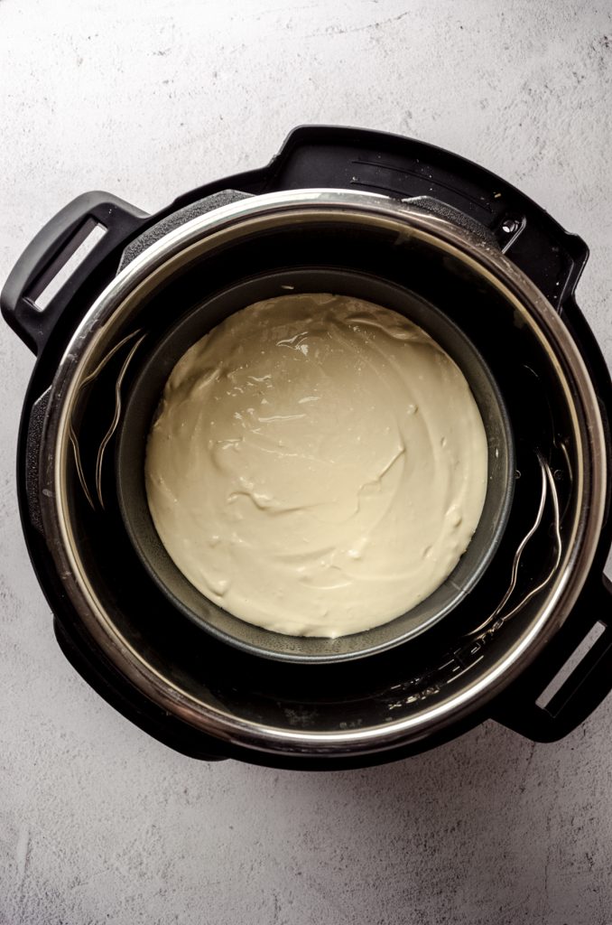 Aerial photo of a springform pan filled with cheesecake batter in an Instant Pot.
