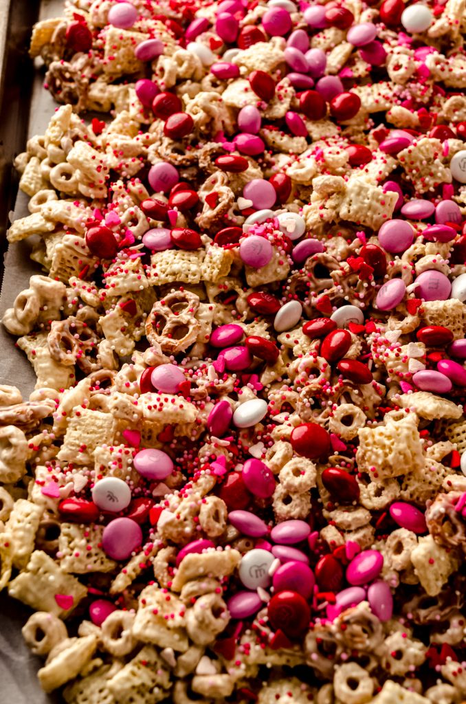 Valentine's Day snack mix on a large baking sheet before being broken into pieces and mixed with gummy candy.