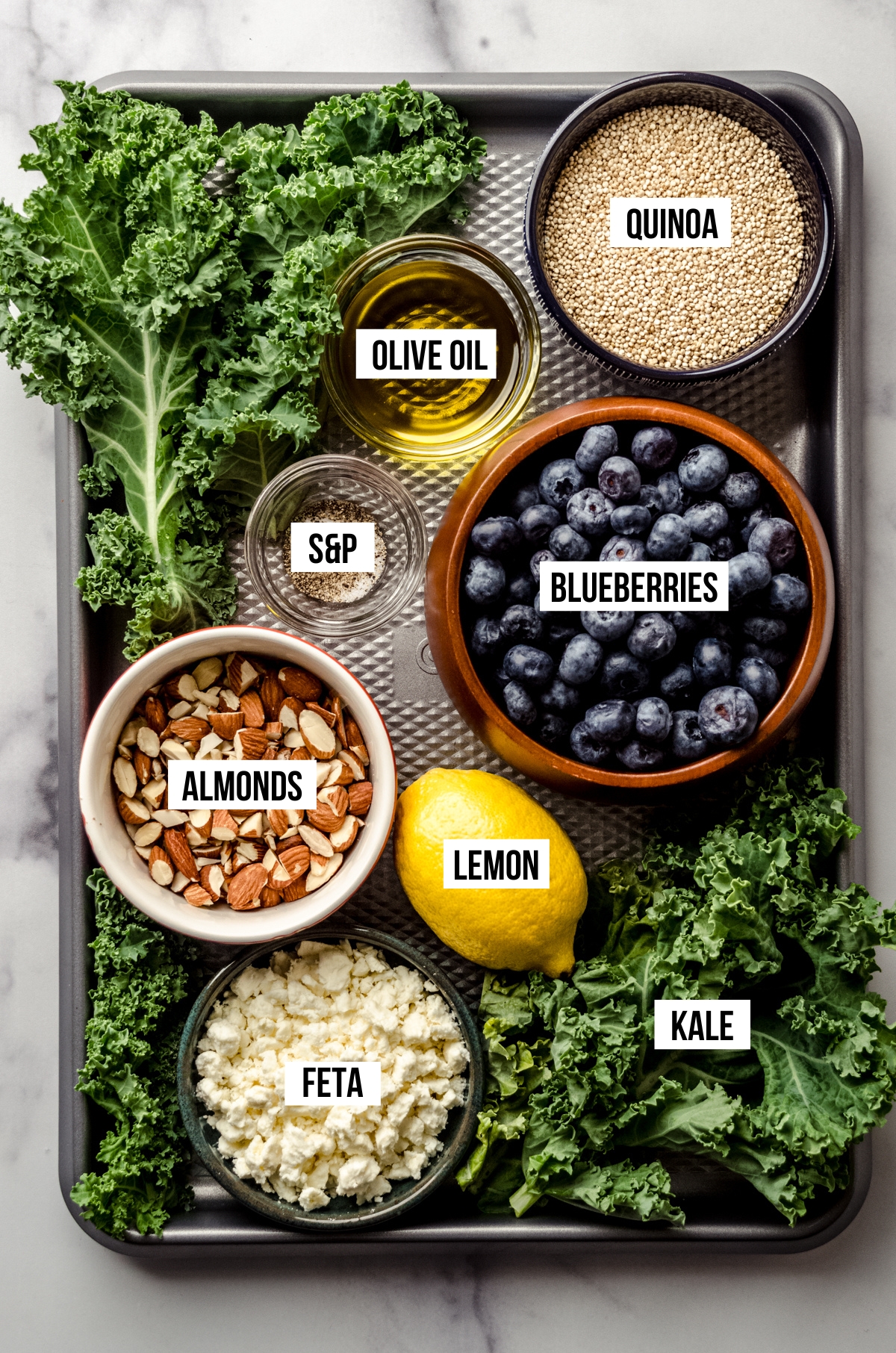 Aerial photo of ingredients for blueberry quinoa kale salad with text overlay.