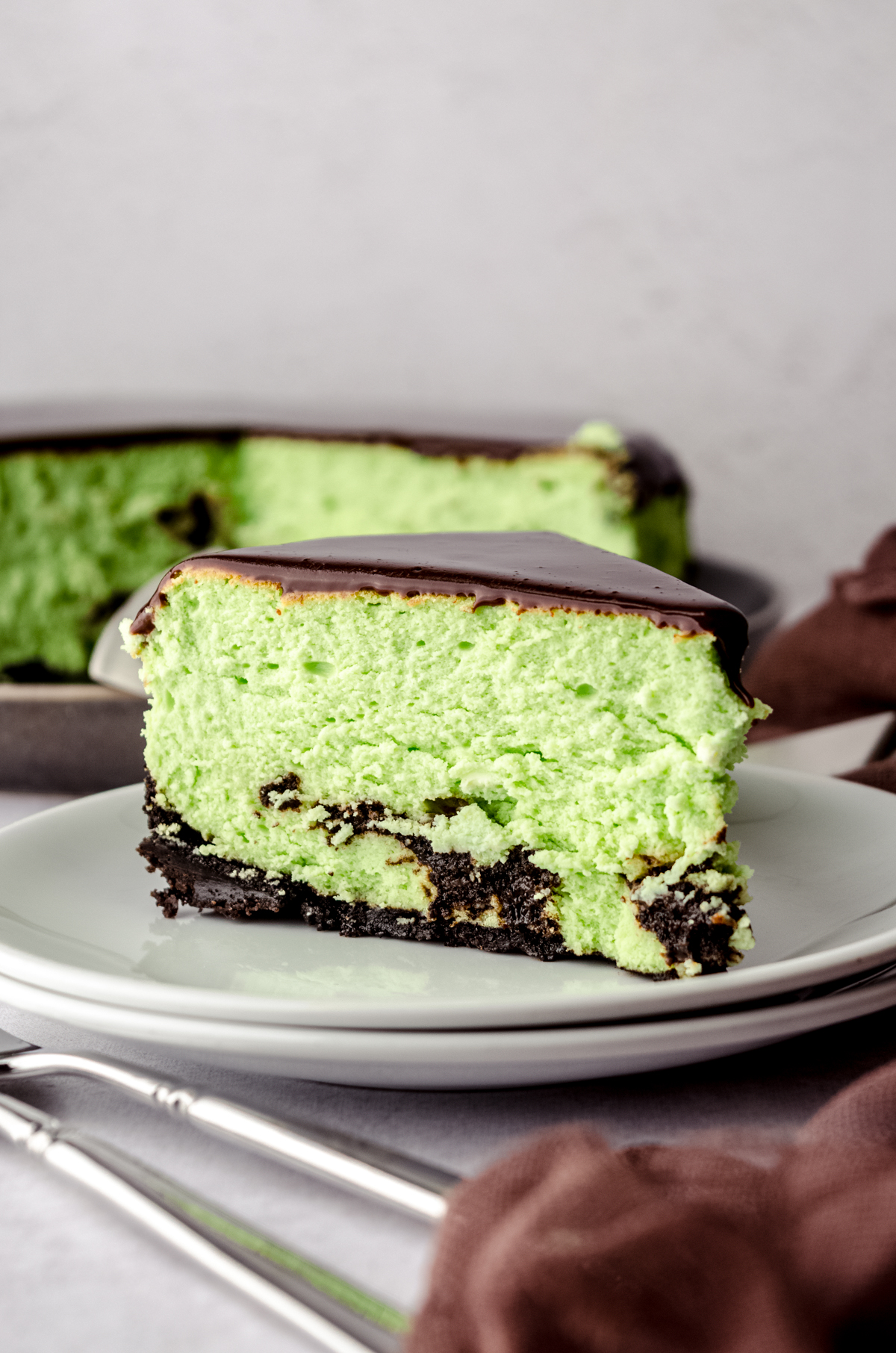 A slice of mint chocolate cheesecake on a plate.