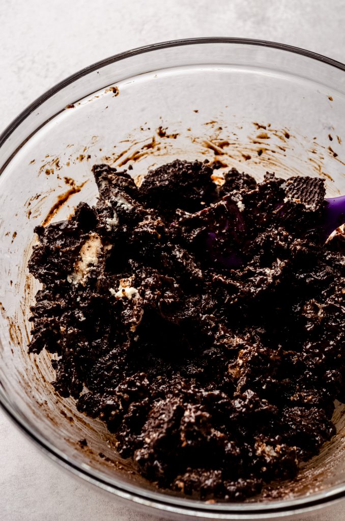 An Oreo and hot fudge mixture in a bowl.