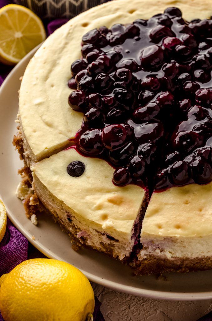 A blueberry lemon cheesecake that has been sliced.