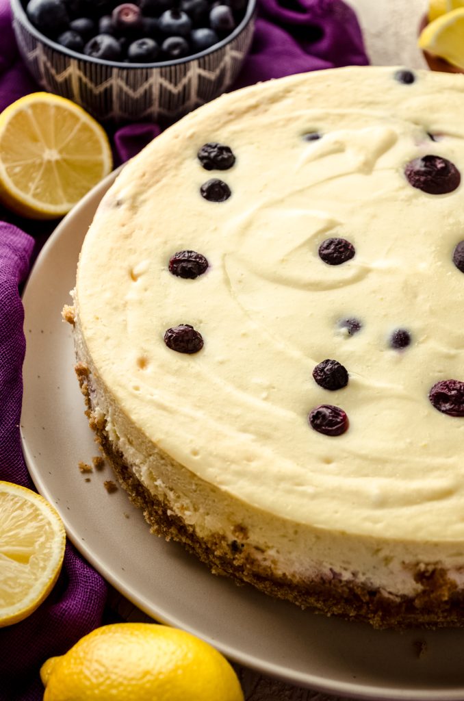 Lemon blueberry cheesecake on a plate.