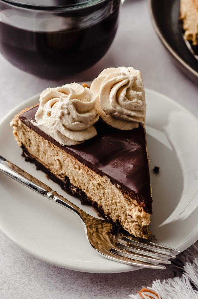 A slice of coffee cheesecake on a plate.