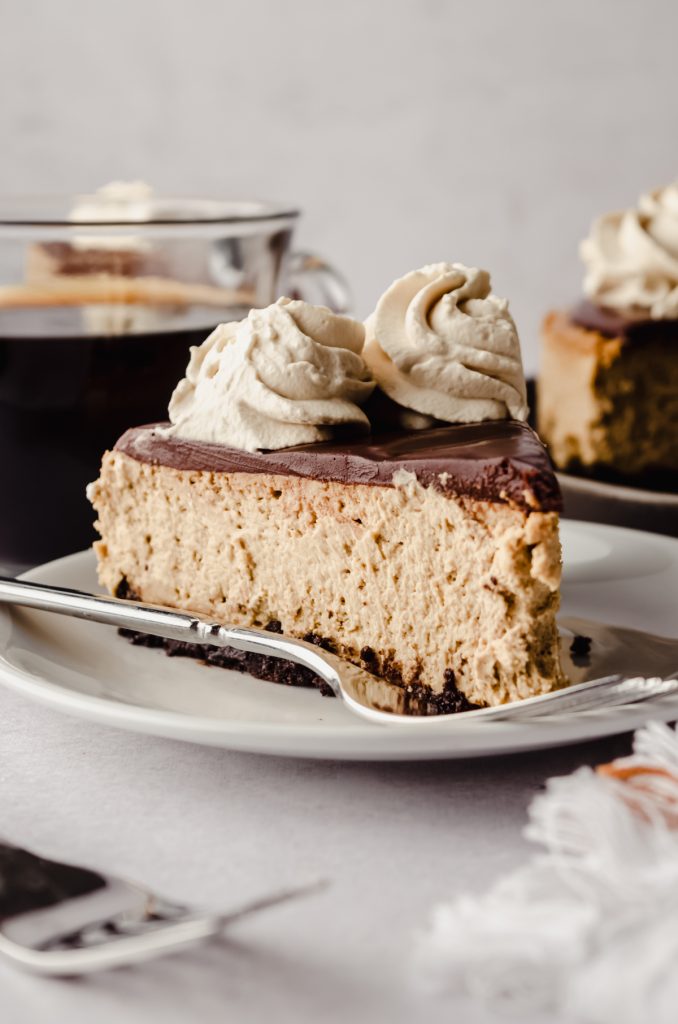A slice of coffee cheesecake on a plate.