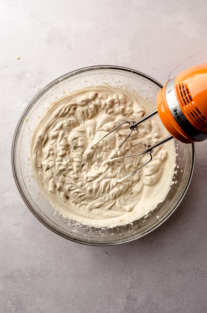 Aerial photo of someone using a hang mixer to make coffee whipped cream.