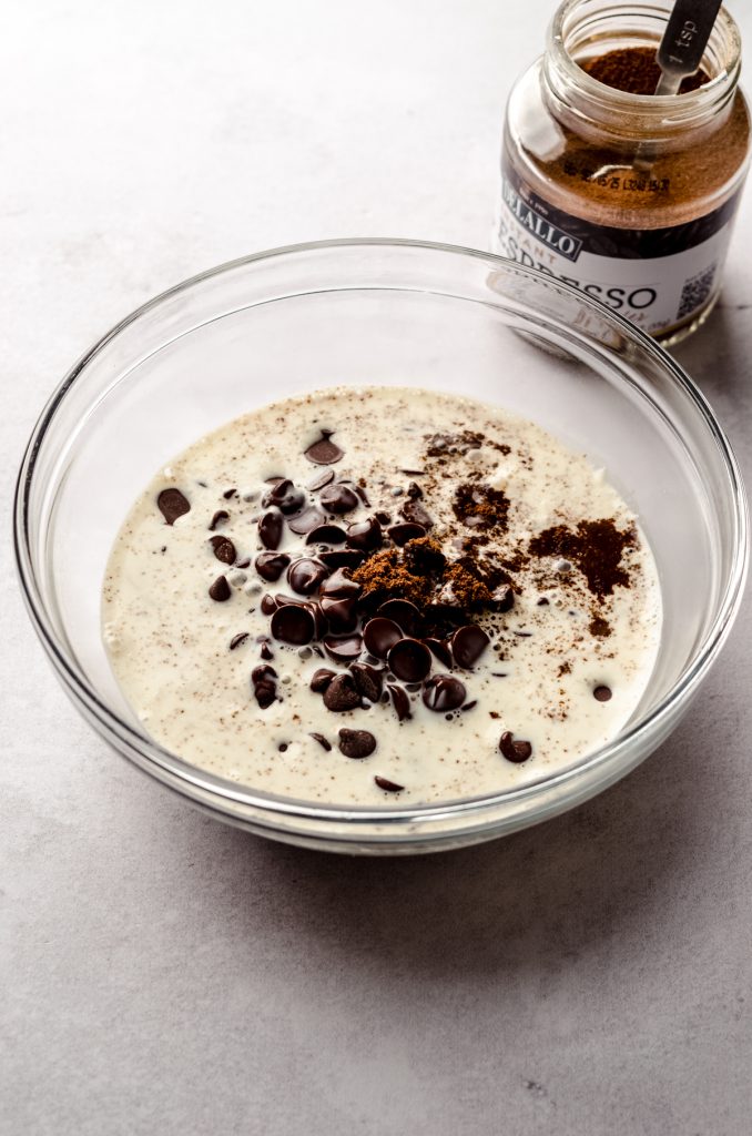 A bowl of chocolate chips, espresso powder, and heavy cream to make chocolate espresso ganache.