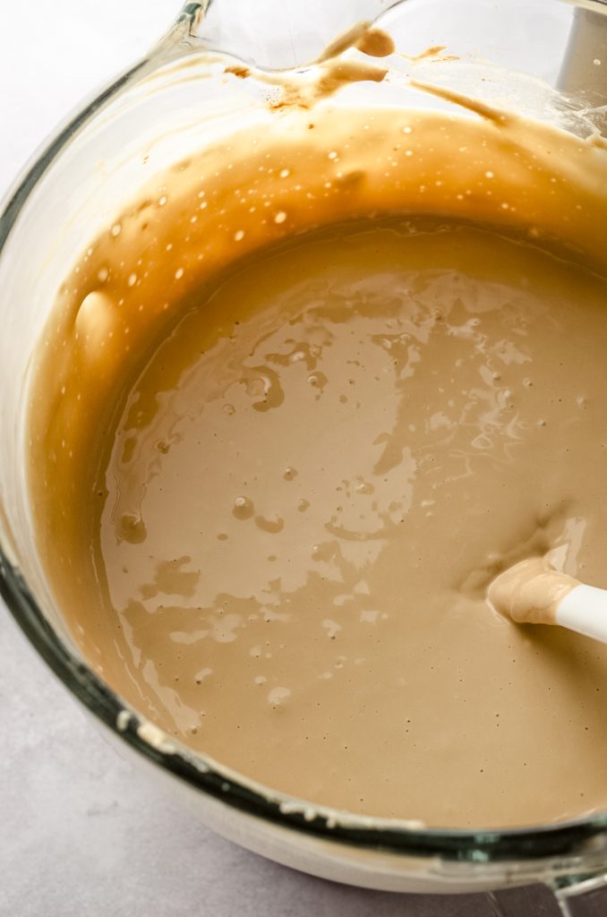 Batter for coffee cheesecake in the bowl of a stand mixer.