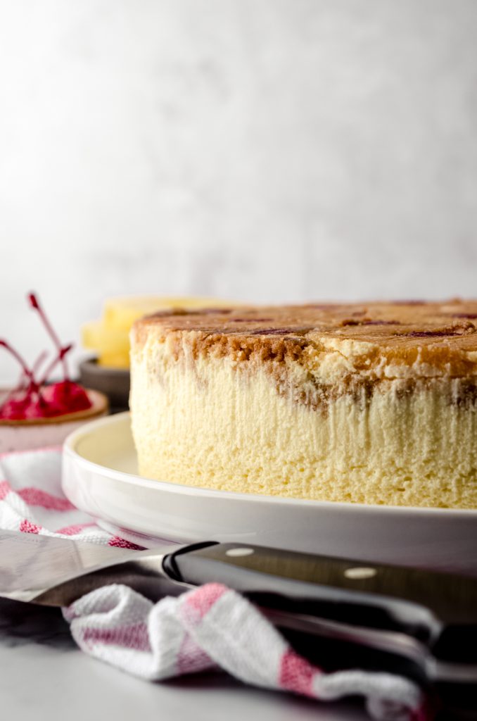 A pineapple upside down cheesecake sitting on a platter.