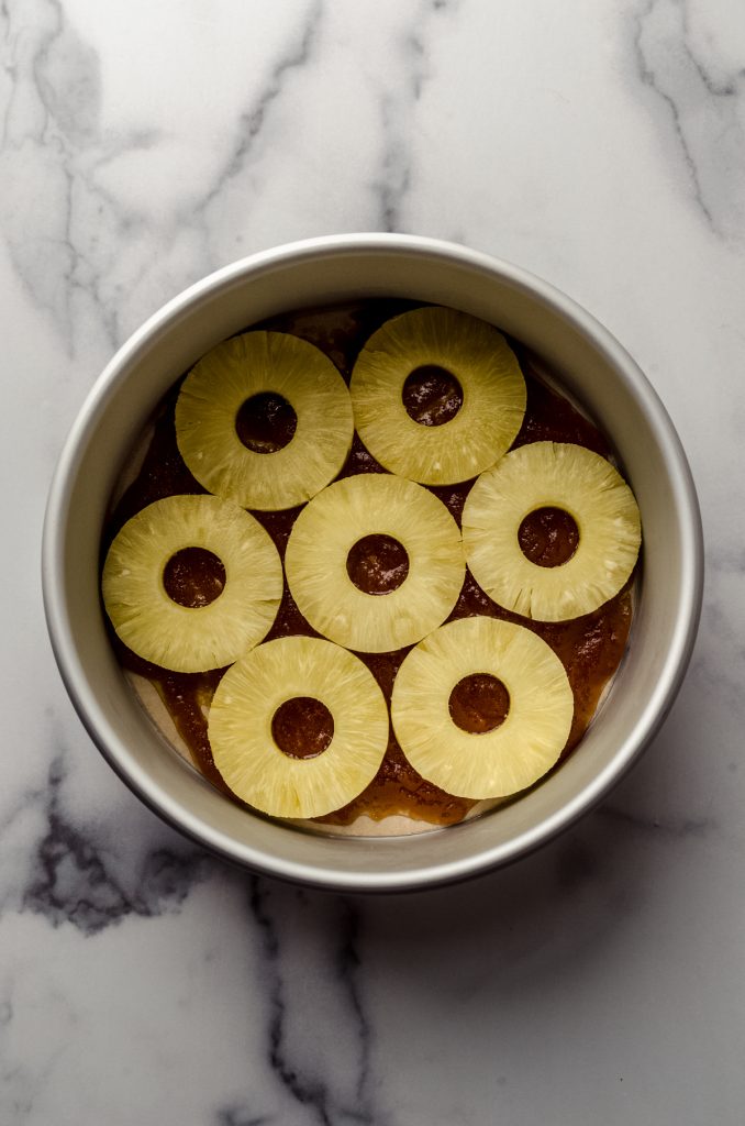 Aerial photo of the pineapple layer in the bottom of a pan to make pineapple upside down cheesecake.