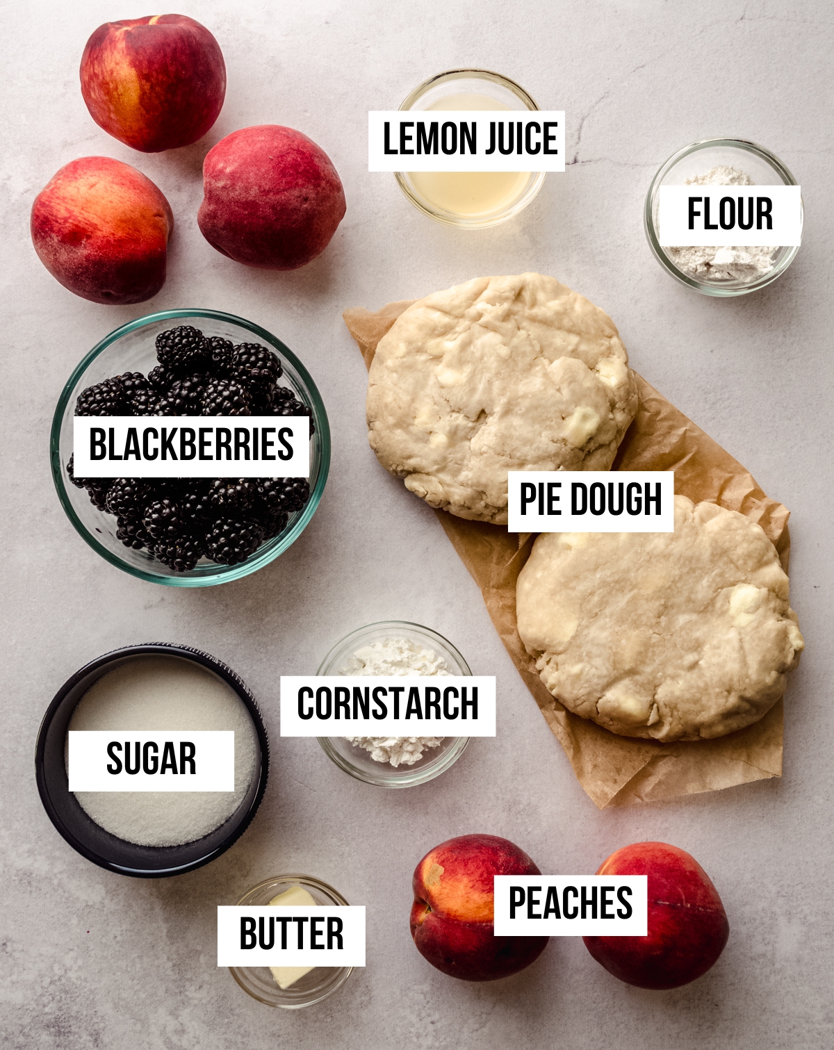 Aerial photo of ingredients to make peach blackberry pie with text overlay labeling each ingredient.