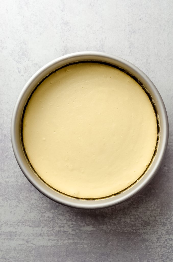 Aerial photo of a baked goat cheese cheesecake in a pan.