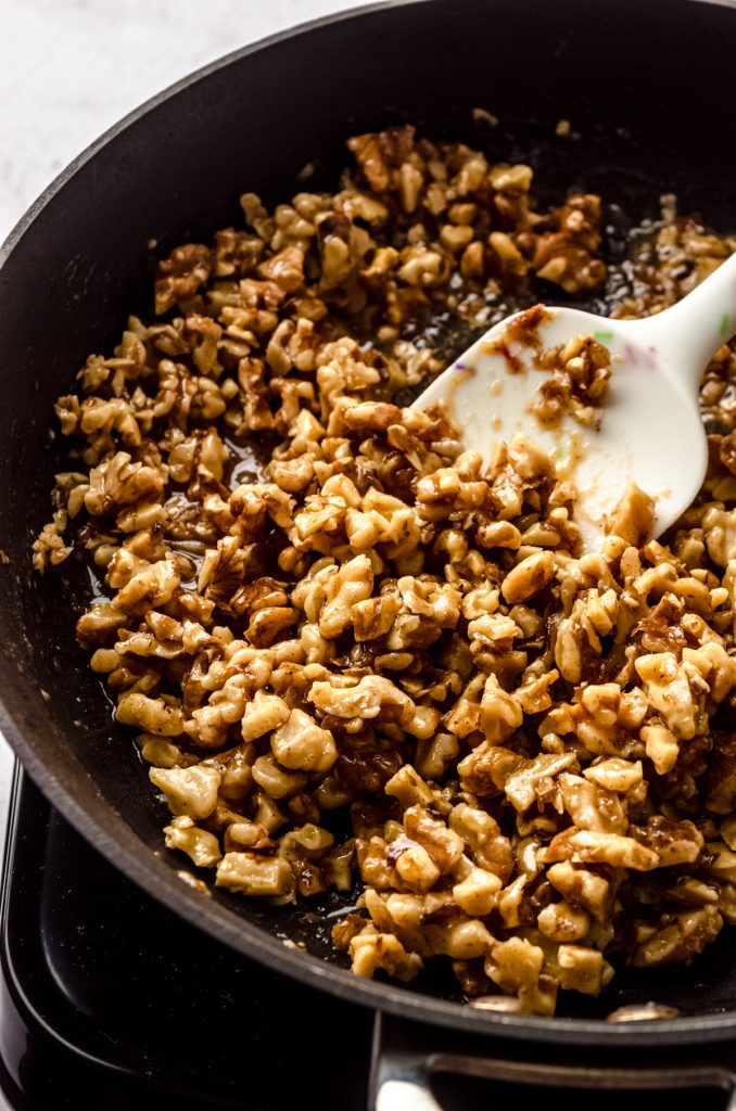 A honey walnut mixture in a saucepan.