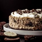 A cookies and cream cheesecake on a plate.