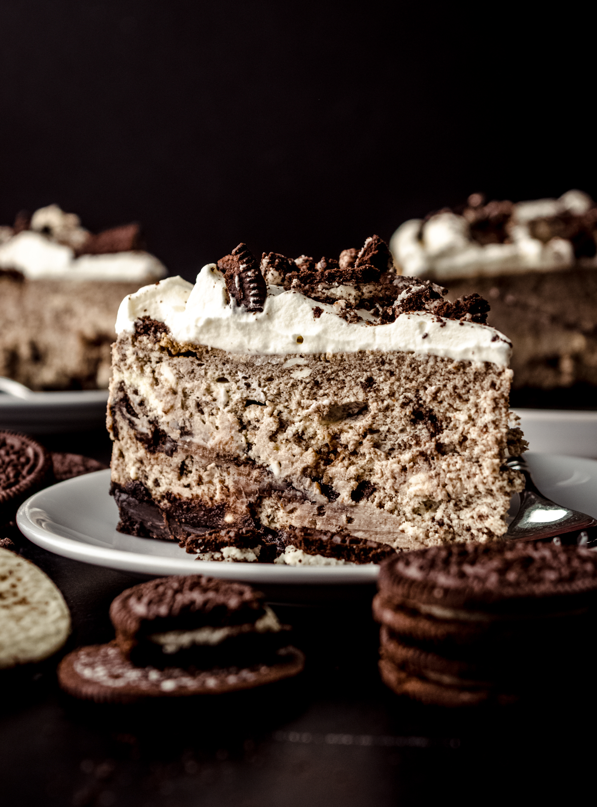 A slice of cookies and cream cheesecake on a plate.