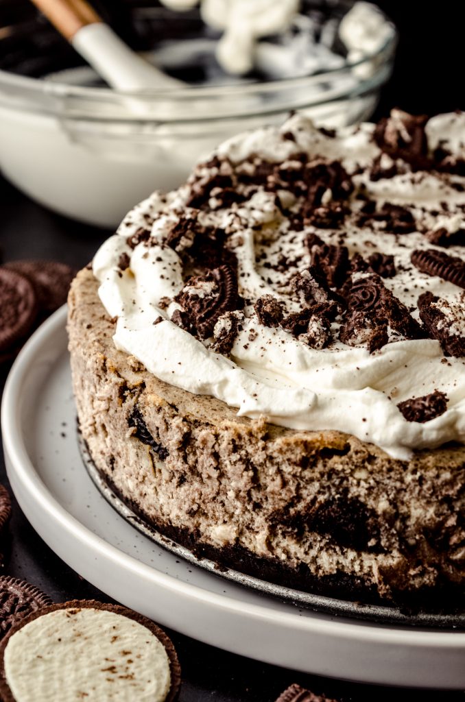 A cookies and cream cheesecake on a plate.