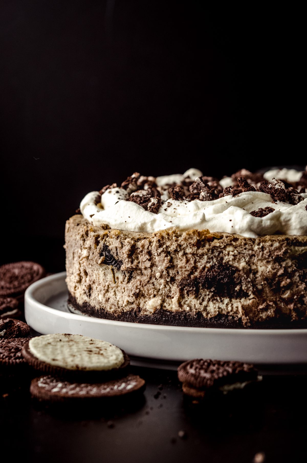 A cookies and cream cheesecake on a plate.