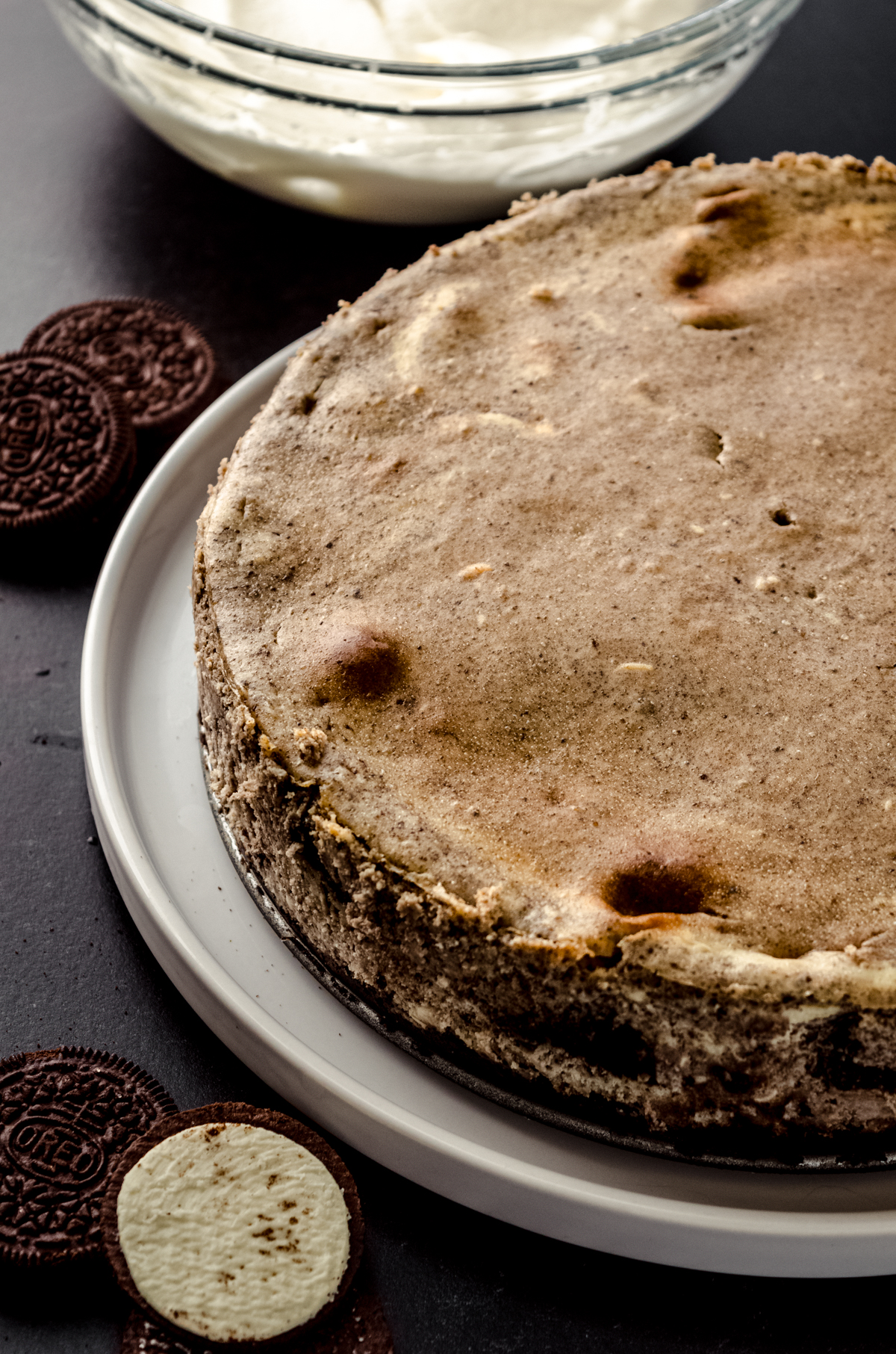 A baked Oreo cheesecake on a plate.