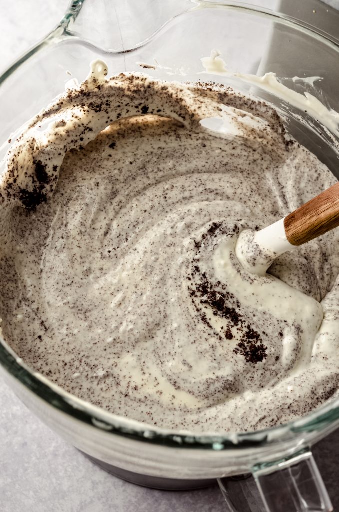 Oreo cheesecake batter in a large bowl with a spatula.